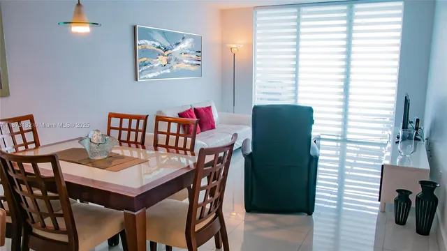 a view of a dining room with furniture and a window