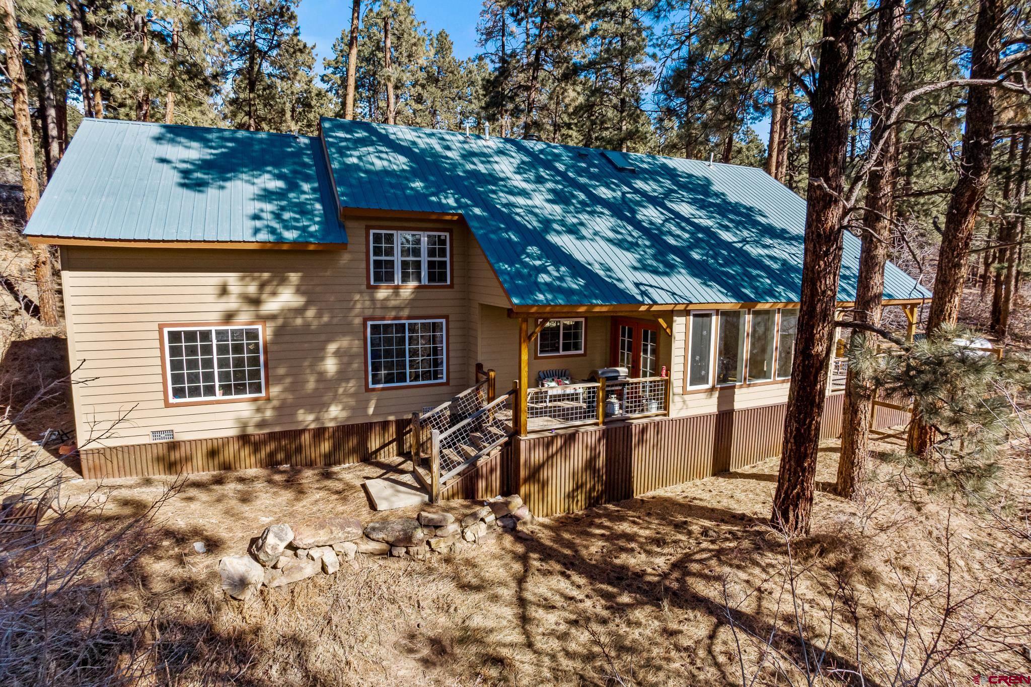 a view of a house with backyard and sitting area