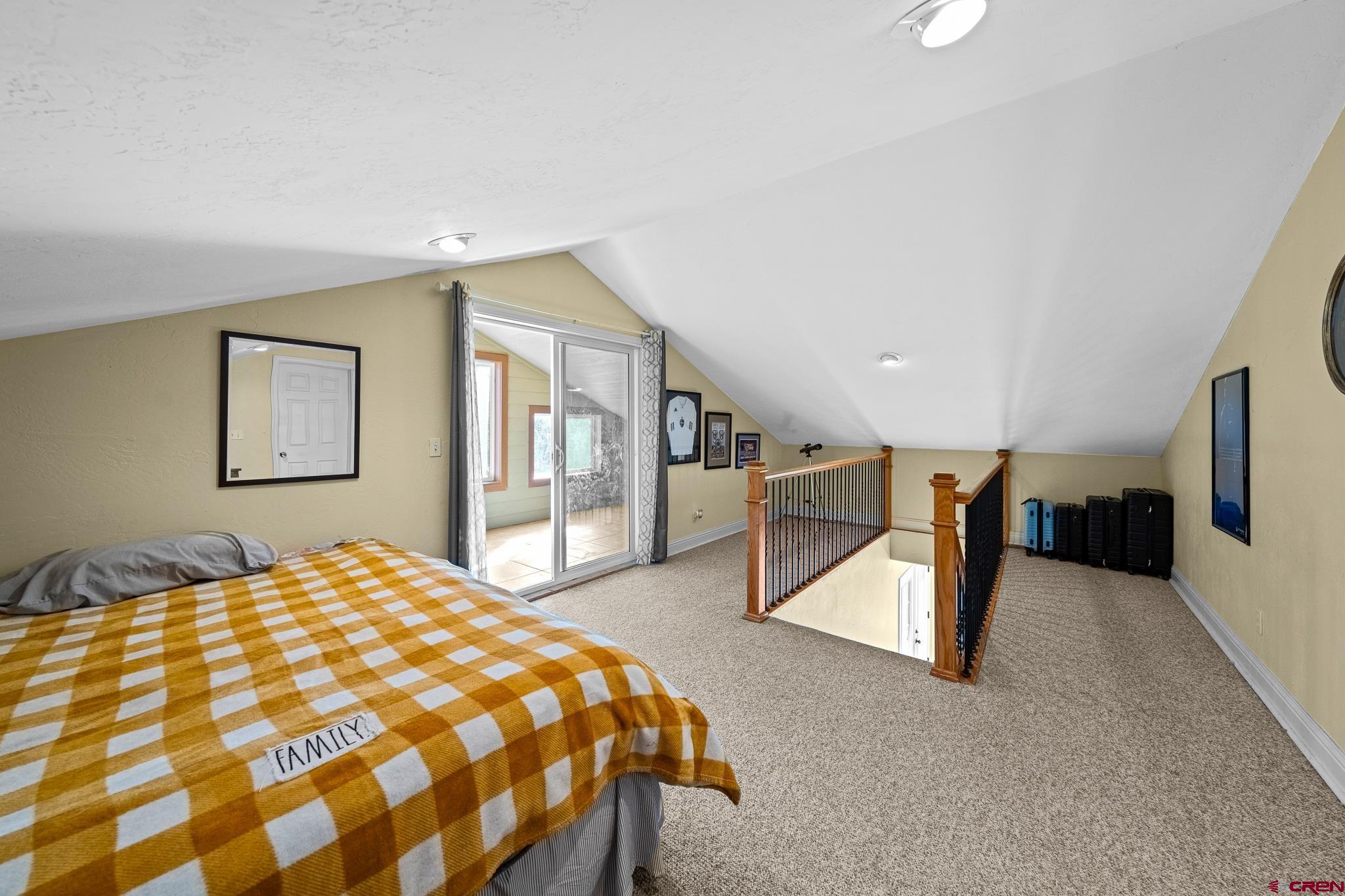 700 Blue Ridge Drive Bayfield, CO 81122 - Photo 19 of 30 a spacious bedroom with a bed and a dresser