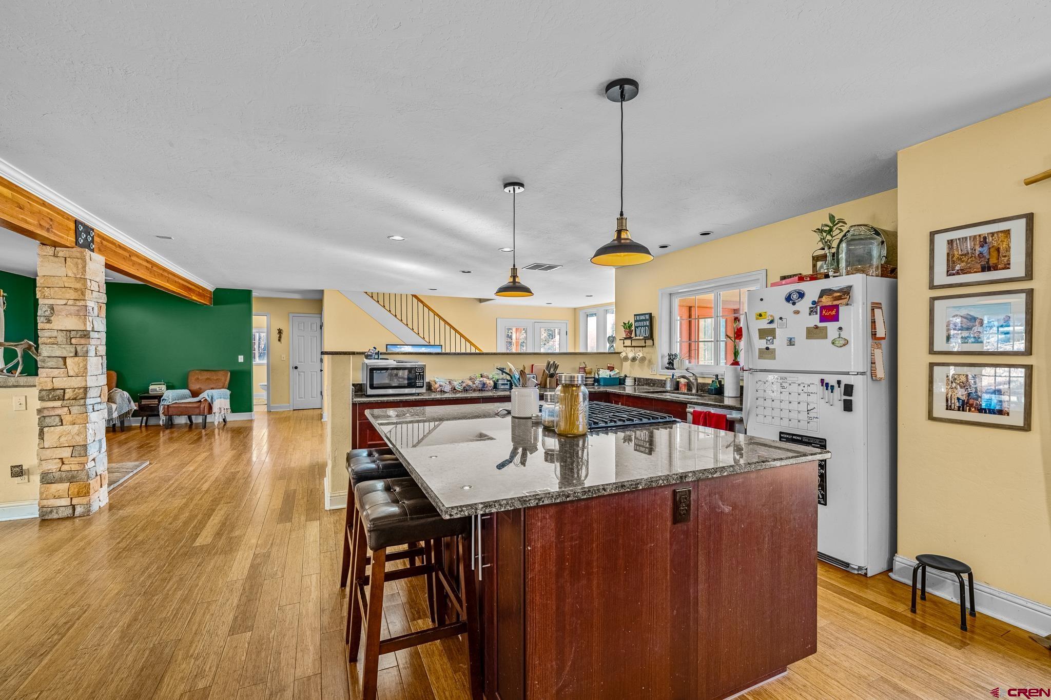 700 Blue Ridge Drive Bayfield, CO 81122 - Photo 8 of 30 a room with lots of wooden furniture and a wooden floor