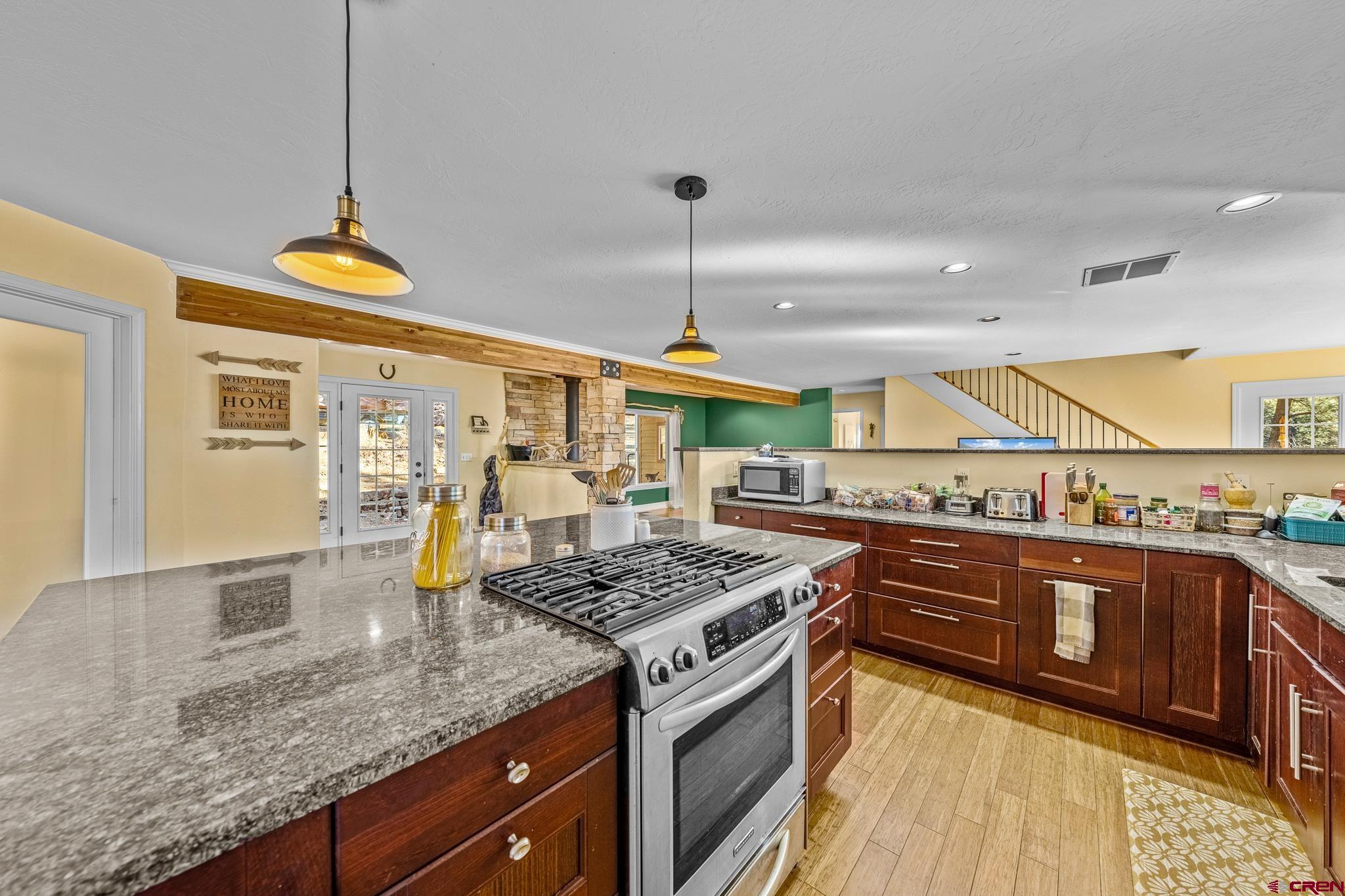700 Blue Ridge Drive Bayfield, CO 81122 - Photo 10 of 30 a kitchen with stainless steel appliances granite countertop a stove and a sink