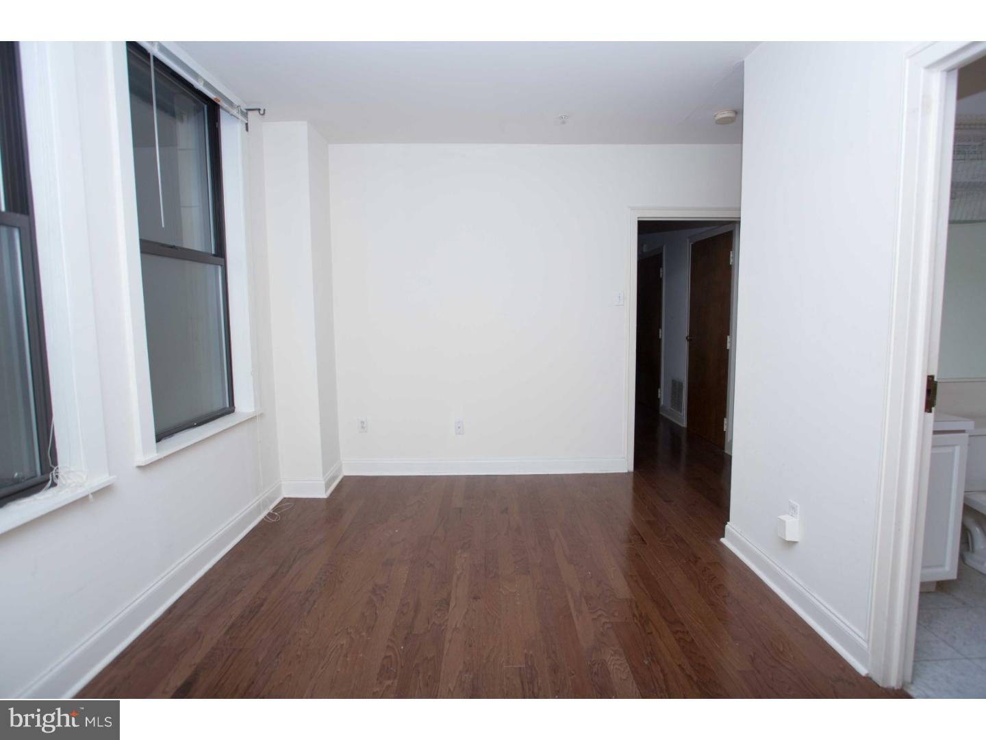 1411-3 Walnut Street, Unit 502 Philadelphia, PA 19102 - Photo 12 of 15 a view of an empty room with wooden floor and a window