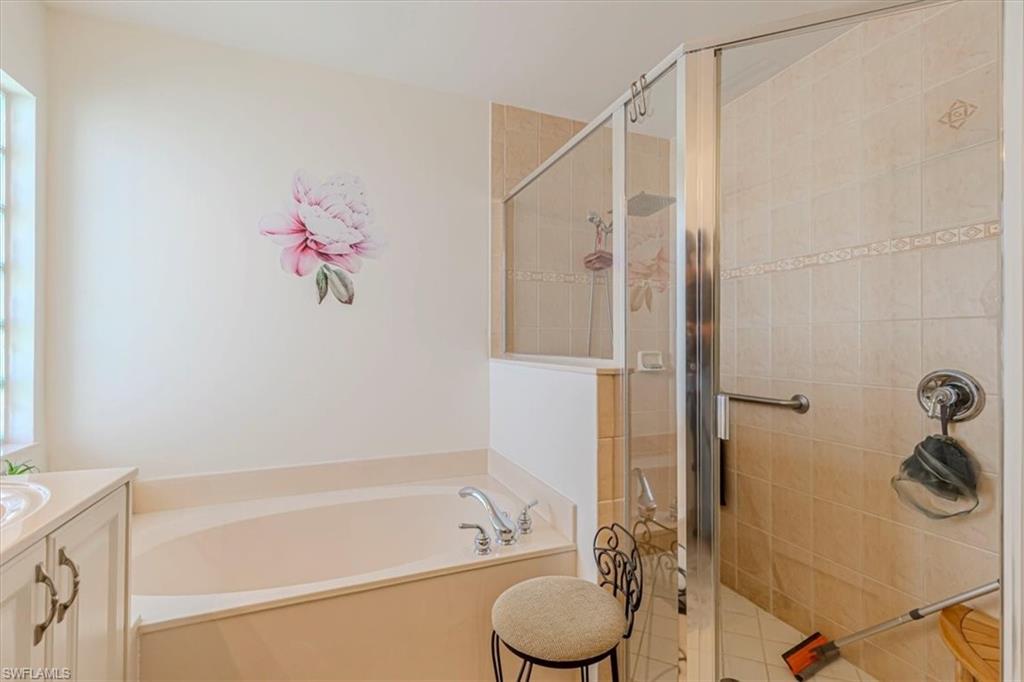 1630 Triangle Palm Terrace Naples, FL 34119 - Photo 17 of 24 a bathroom with a granite countertop sink toilet and shower