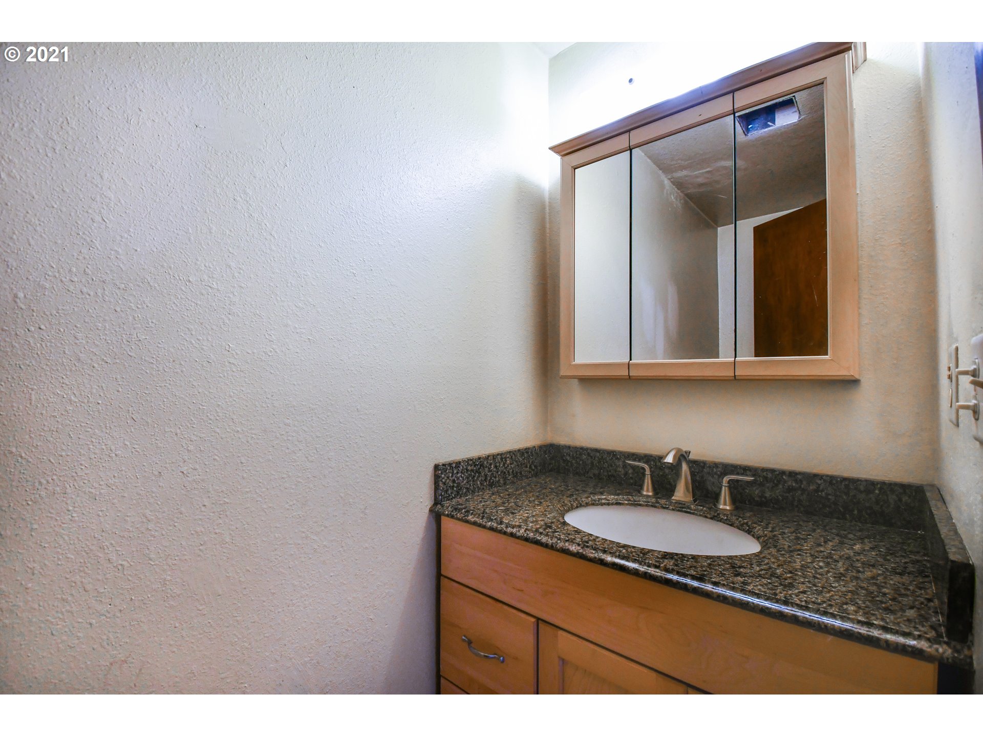 5231 G Street Springfield, OR 97478 - Photo 12 of 17 a bathroom with a sink and a mirror