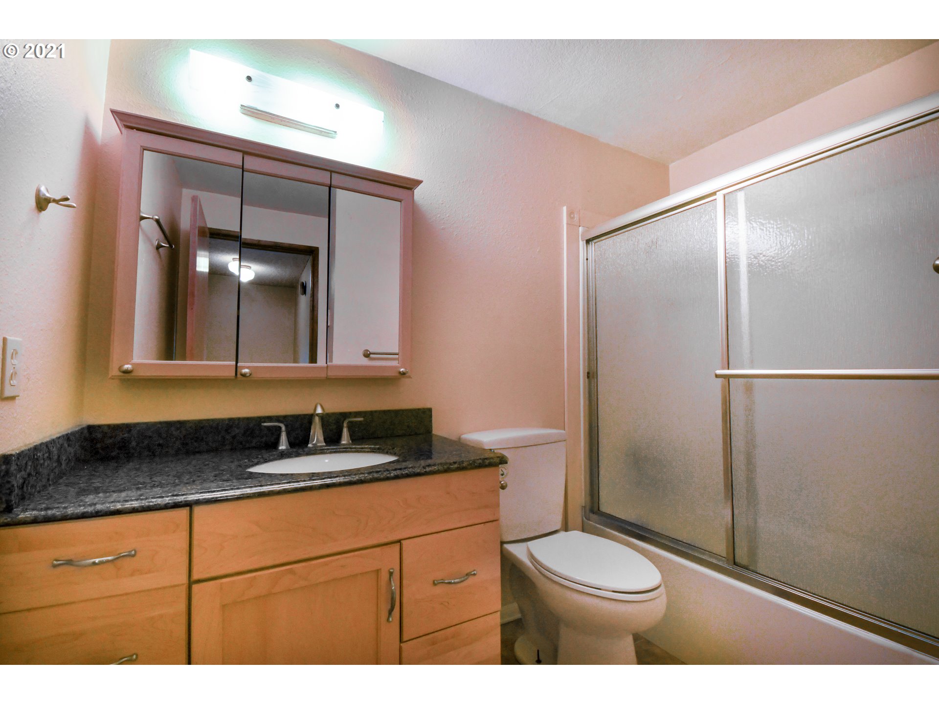 5231 G Street Springfield, OR 97478 - Photo 14 of 17 a bathroom with a sink a toilet a mirror and shower