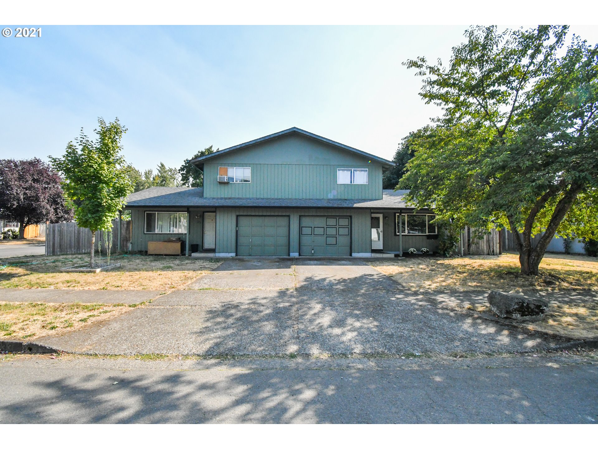 5231 G Street Springfield, OR 97478 - Photo 17 of 17 a front view of a house with a yard and garage