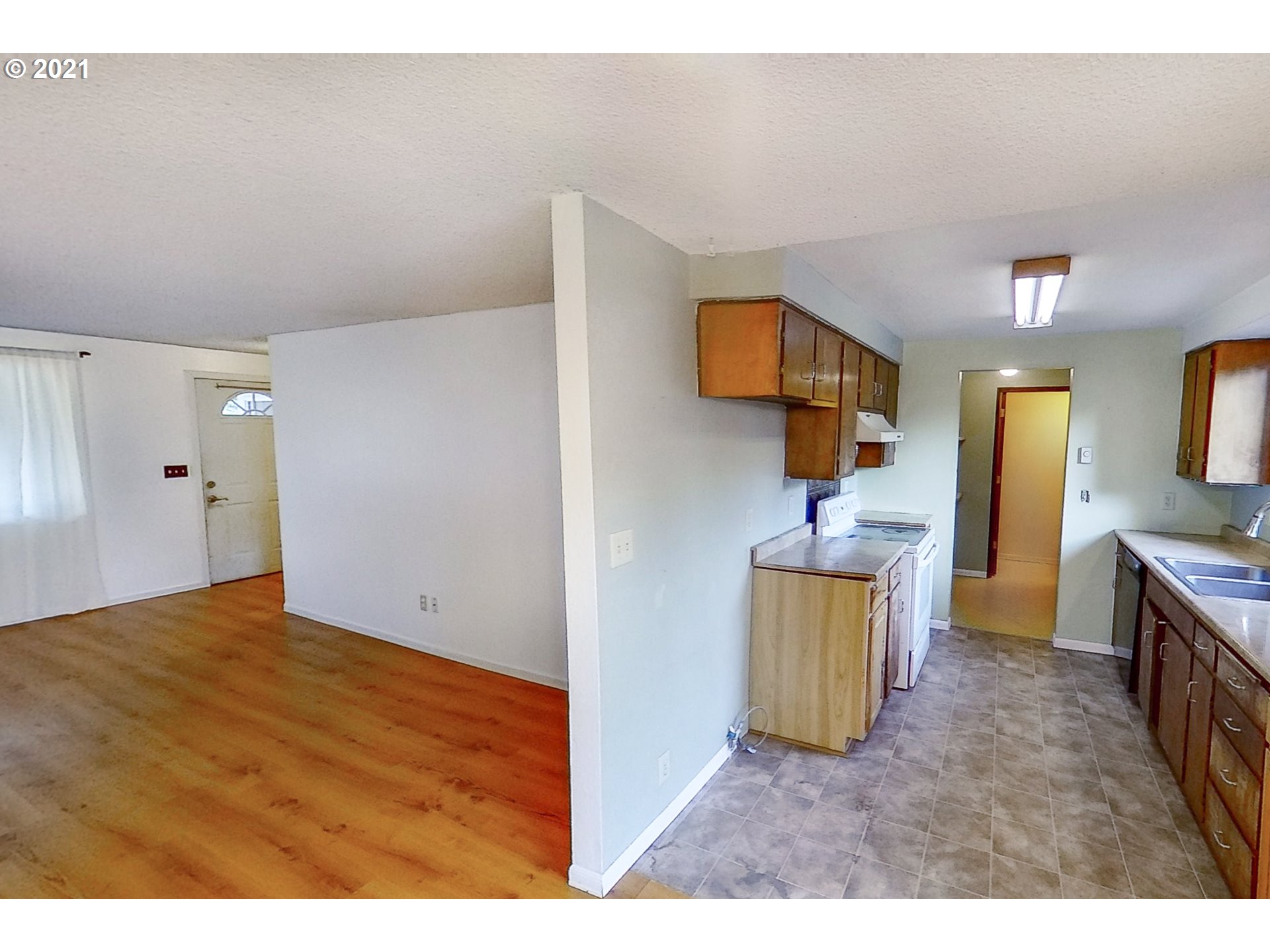 5231 G Street Springfield, OR 97478 - Photo 4 of 17 a view of a kitchen with furniture and a flat screen tv
