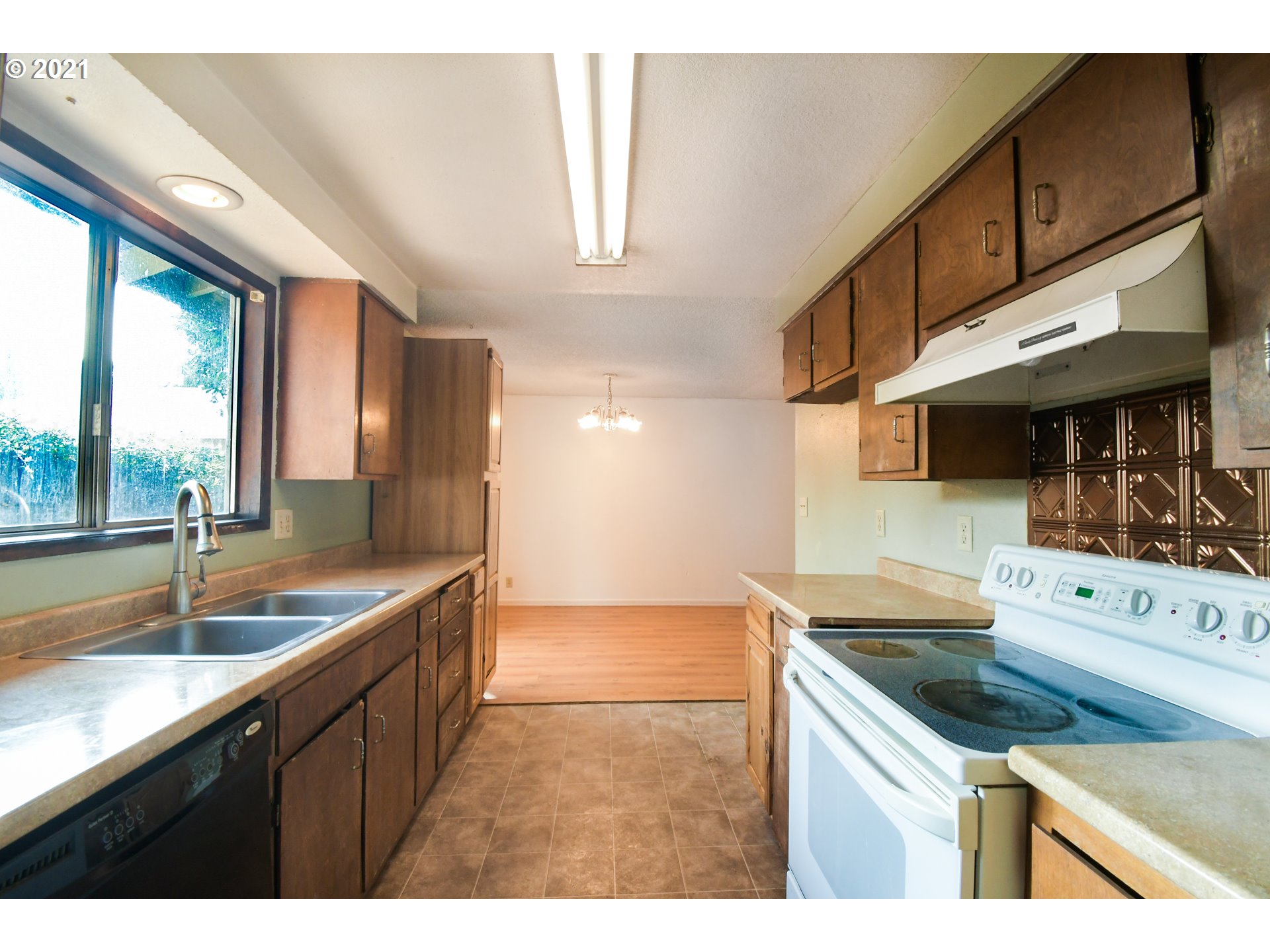 5231 G Street Springfield, OR 97478 - Photo 6 of 17 a kitchen with a sink a counter top space and living room