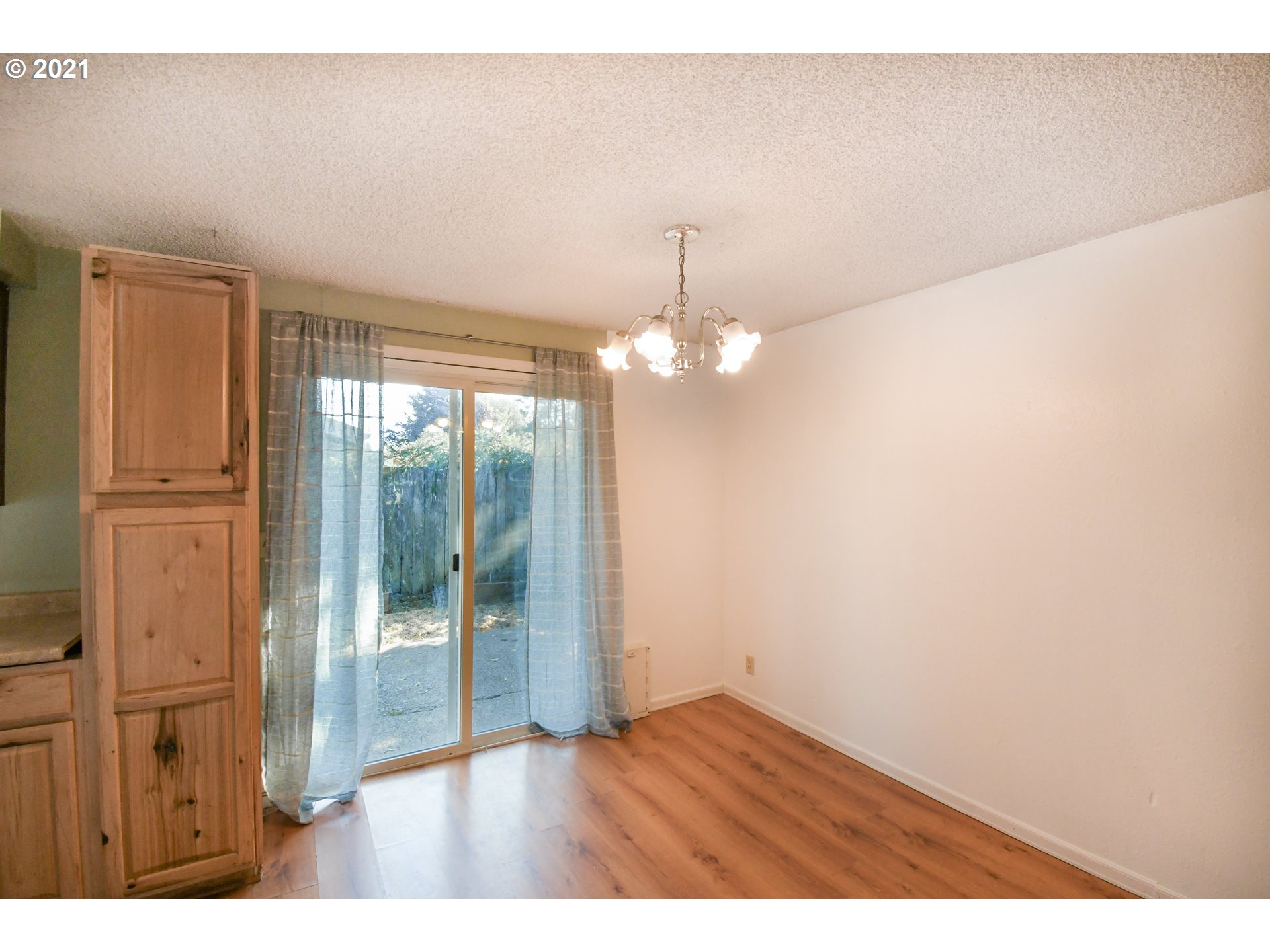 5231 G Street Springfield, OR 97478 - Photo 9 of 17 a view of empty room with wooden floor and fan