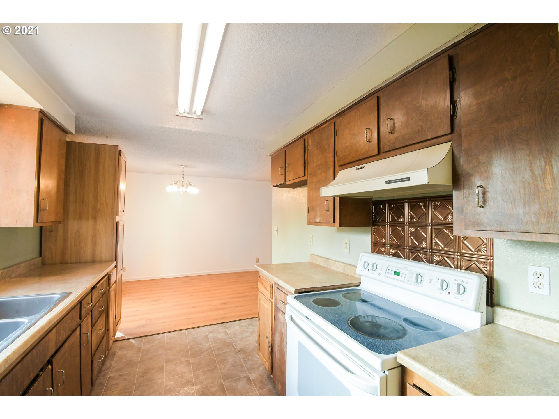 5231 G Street Springfield, OR 97478 - Photo 10 of 17 a kitchen with stainless steel appliances granite countertop a sink and a stove