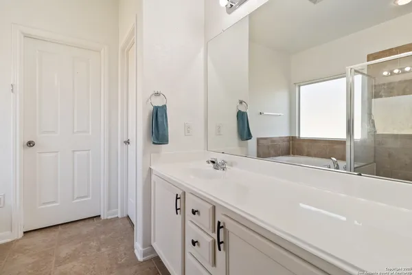 a bathroom with a double vanity sink and mirror