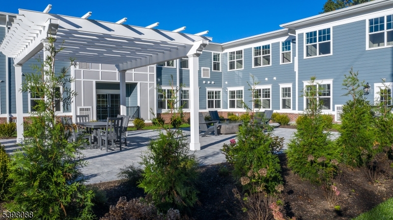 663 Springfield Avenue, Unit 53 Berkeley Heights, NJ 07922 - Photo 3 of 14 a view of a house with a chairs and table in a patio