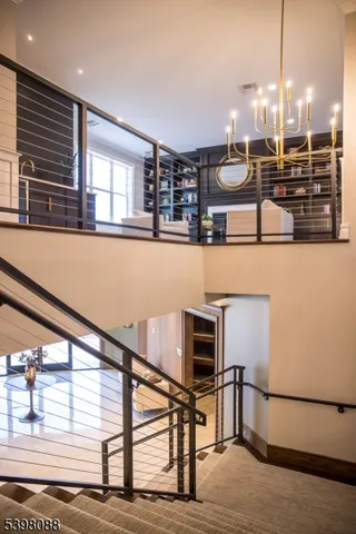 a kitchen with stainless steel appliances granite countertop a oven and a view of living room