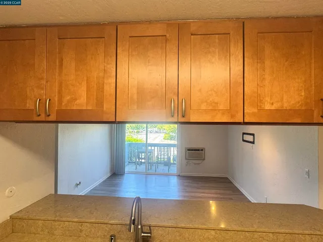 a view of a kitchen with an empty space and a window