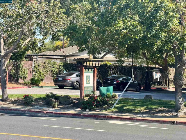 a white toilet sitting next to a bath tub