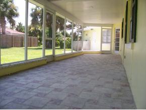 903 South Riverside Drive Indialantic, FL 32903 - Photo 7 of 8 a view of a house with a backyard and floor to ceiling window