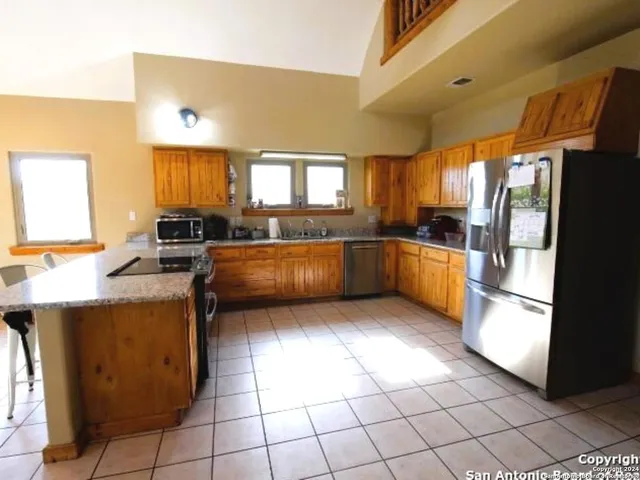a kitchen with stainless steel appliances granite countertop a sink counter space and cabinets