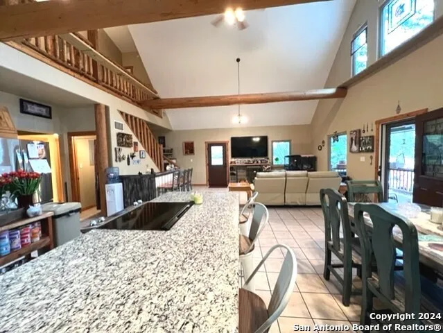 a living room with stainless steel appliances kitchen island granite countertop furniture and a kitchen view