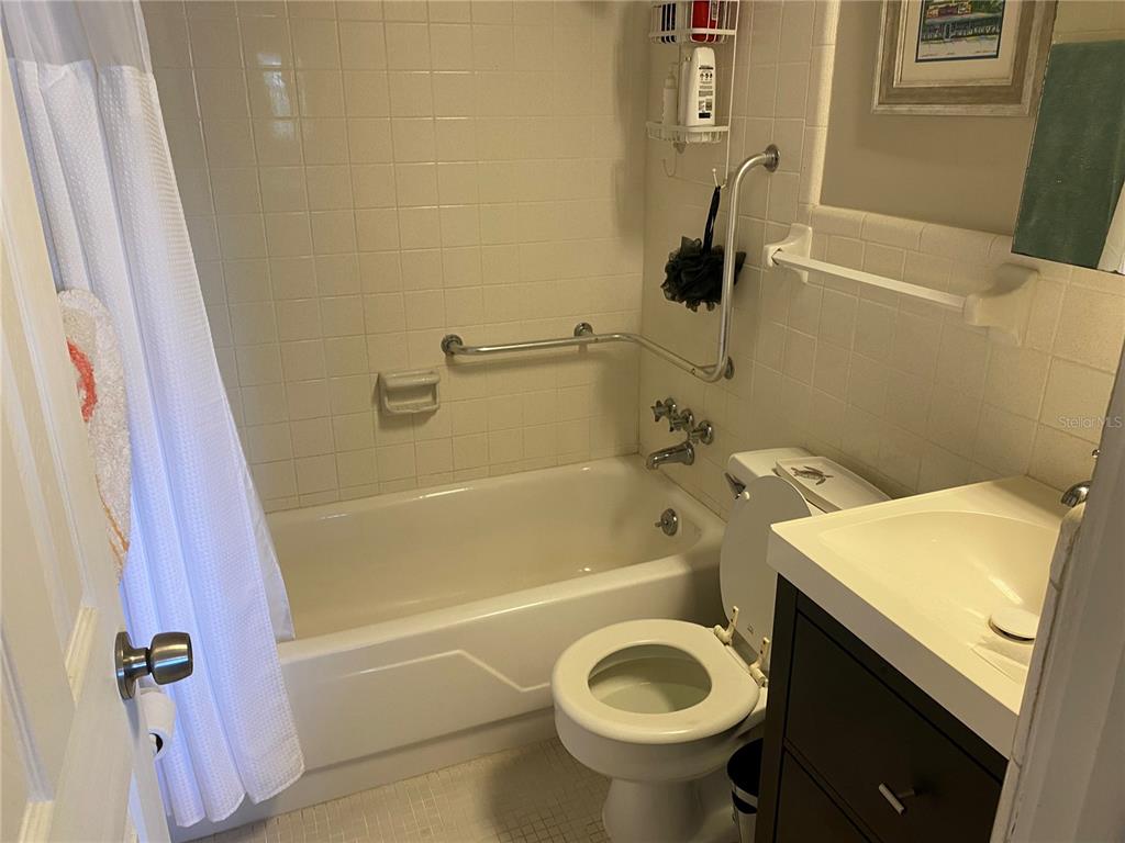 8455 112th Street North, Unit 212 Seminole, FL 33772 - Photo 11 of 21 a bathroom with a sink a toilet and bathtub