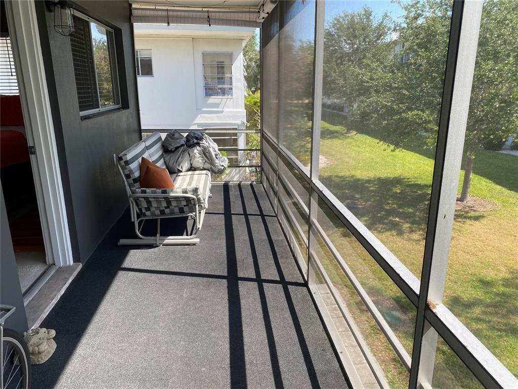 8455 112th Street North, Unit 212 Seminole, FL 33772 - Photo 13 of 21 a view of a balcony with floor to ceiling window with wooden floor