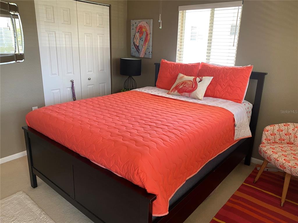 8455 112th Street North, Unit 212 Seminole, FL 33772 - Photo 9 of 21 a bedroom with a bed and wooden floor