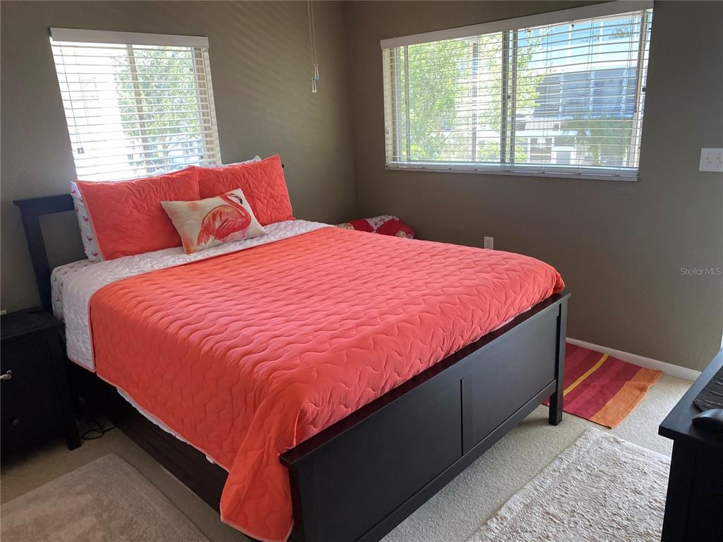 8455 112th Street North, Unit 212 Seminole, FL 33772 - Photo 10 of 21 a bed sitting in a bedroom next to a window