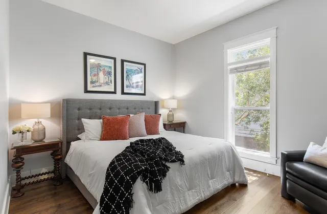 a bedroom with a large bed and a window