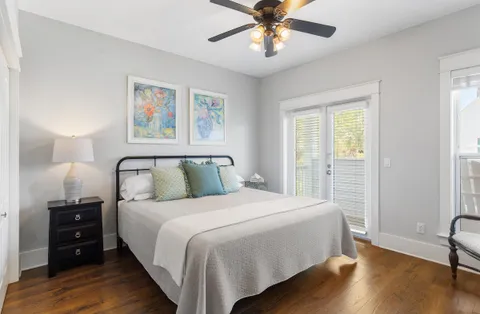 a bedroom with a large bed and a chandelier
