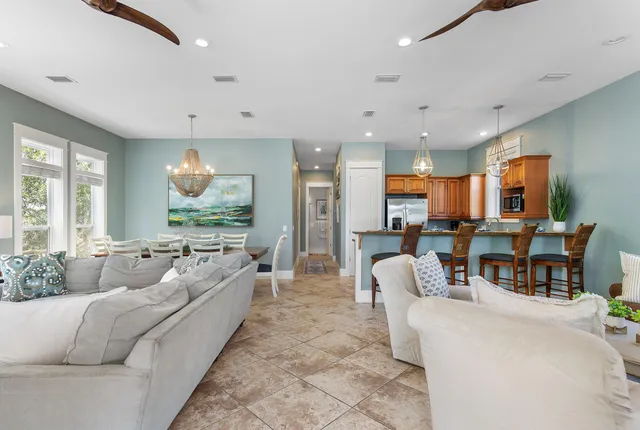 a living room with furniture kitchen and a large window