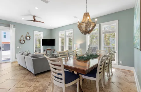 a dining room with furniture a chandelier and a large mirror
