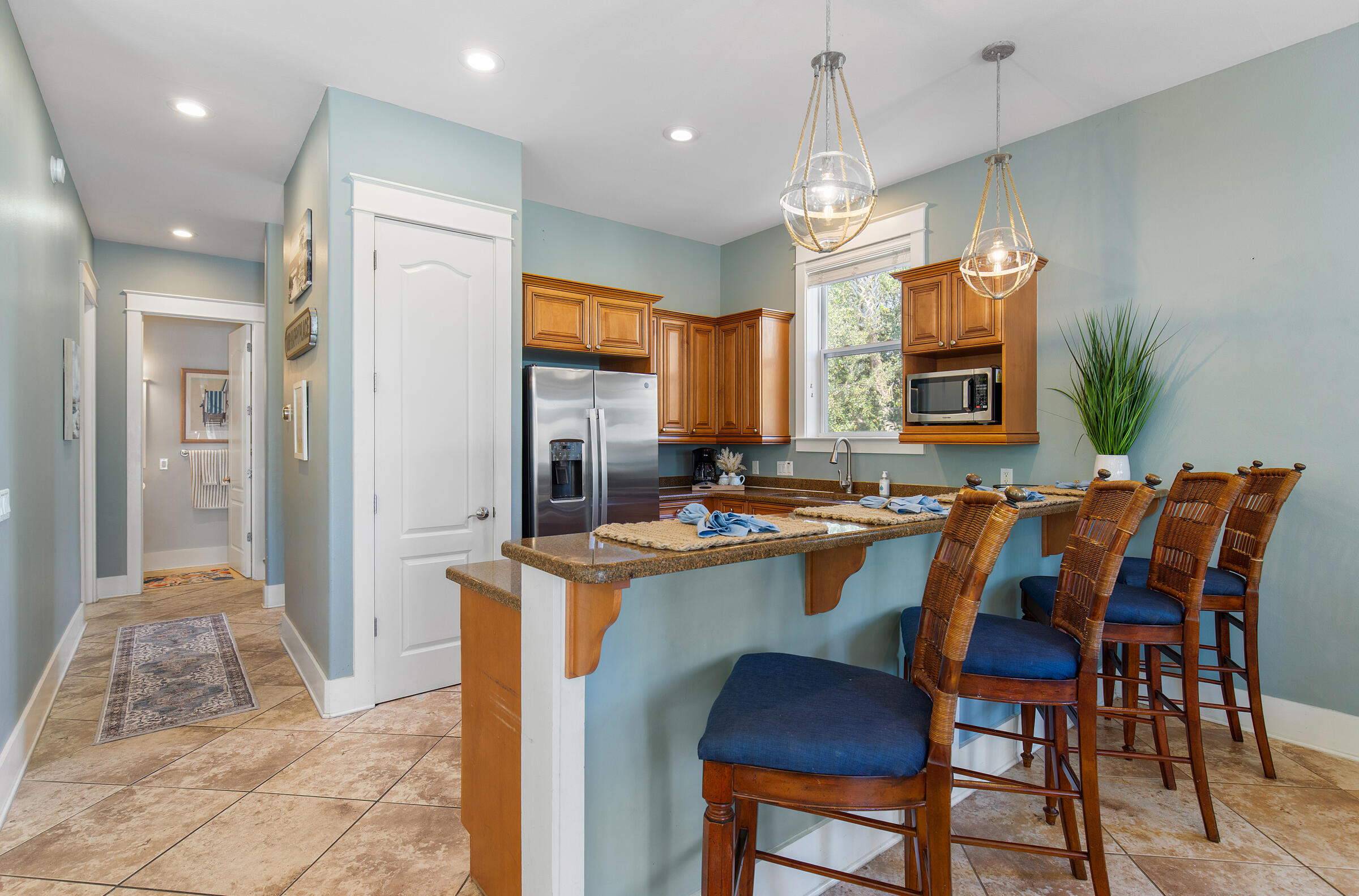 8 Dunes Estates Boulevard Santa Rosa Beach, FL 32459 - Photo 10 of 42 a dining hall with stainless steel appliances kitchen island granite countertop a table chairs and a refrigerator