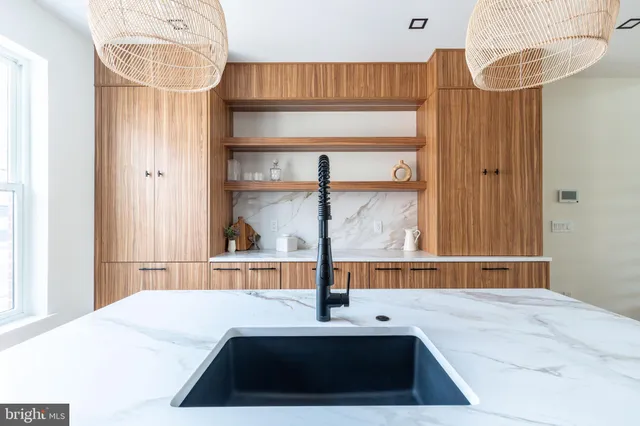 a spacious bedroom with a bed and table chair