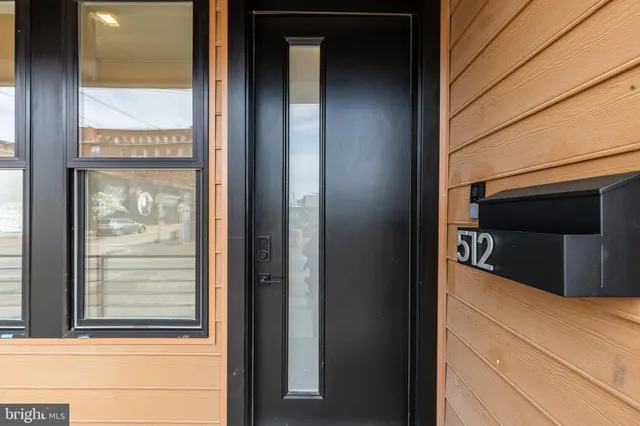 a room with a window and a potted plant
