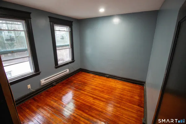 a view of a room with window and wooden floor