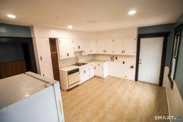 a kitchen with stainless steel appliances a refrigerator and a stove top oven