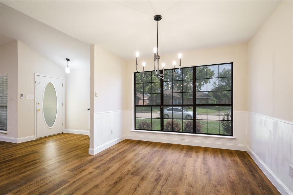 2017 Stein Way Carrollton, TX 75007 - Photo 17 of 18 a view of an empty room with wooden floor and a window