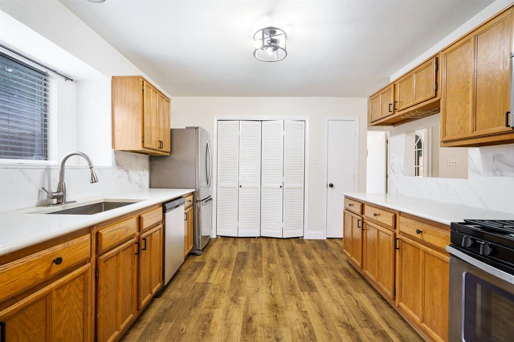 2017 Stein Way Carrollton, TX 75007 - Photo 3 of 18 a kitchen with stainless steel appliances a sink cabinets and wooden floor