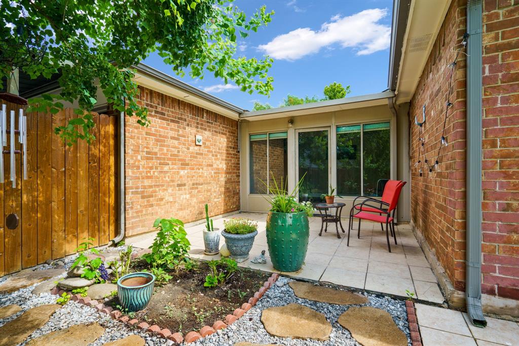 2017 Stein Way Carrollton, TX 75007 - Photo 8 of 18 a view of a chair and table in patio with potted plants