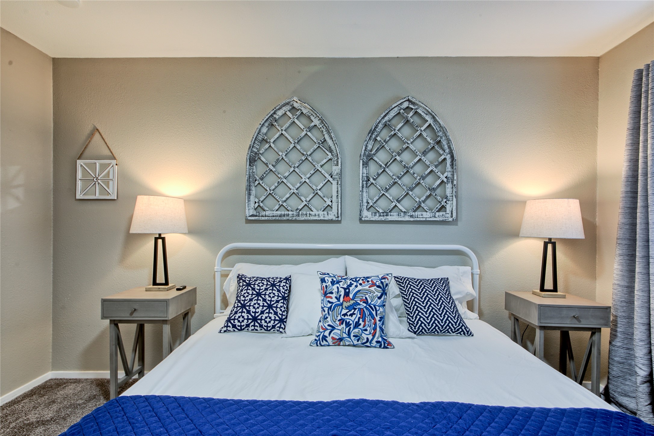 157 Comanche Point Leander, TX 78645 - Photo 18 of 36 a bed sitting in a bedroom next to a lamp with wooden floor