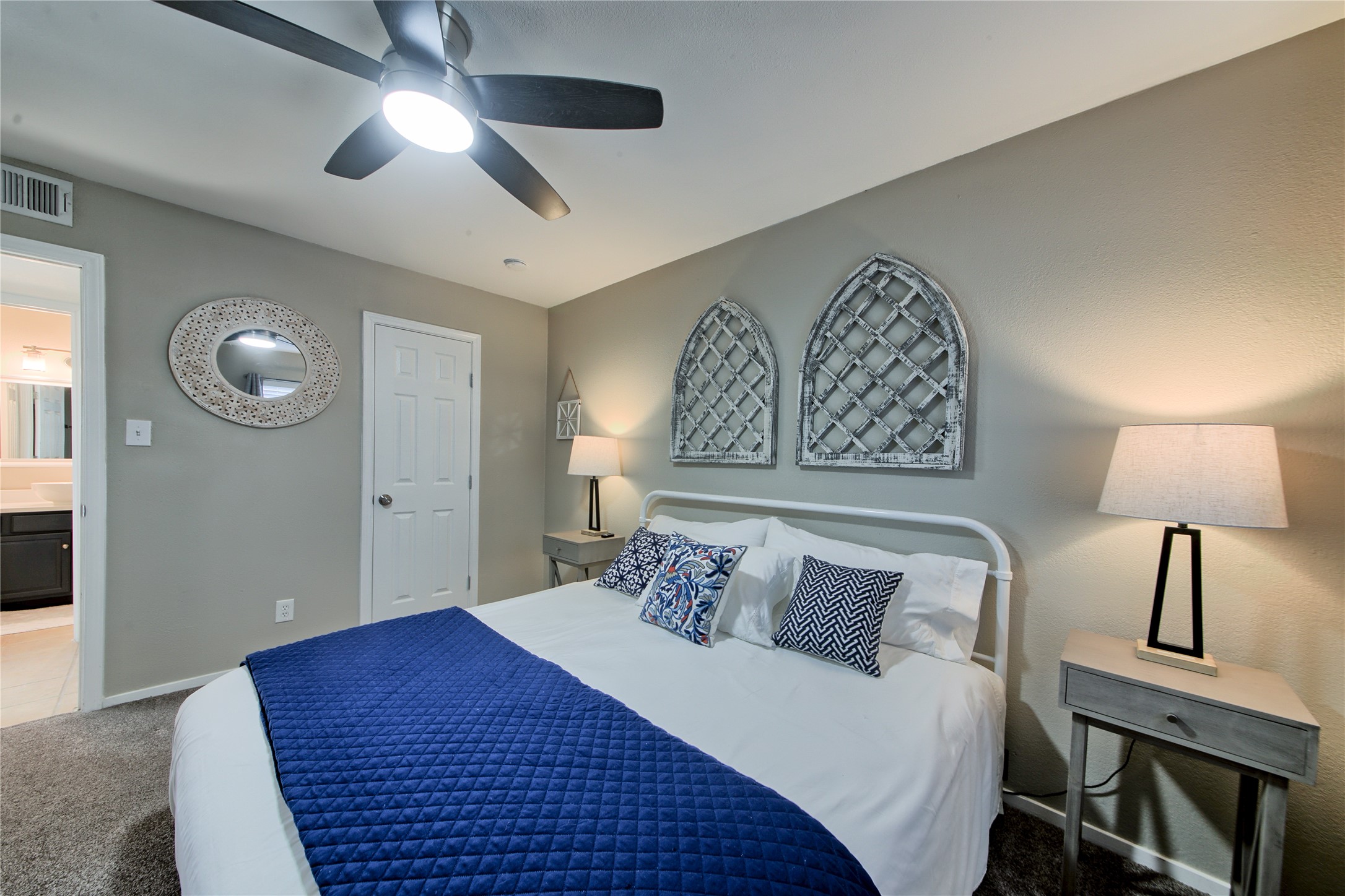 157 Comanche Point Leander, TX 78645 - Photo 19 of 36 a bedroom with a large bed and a lamp