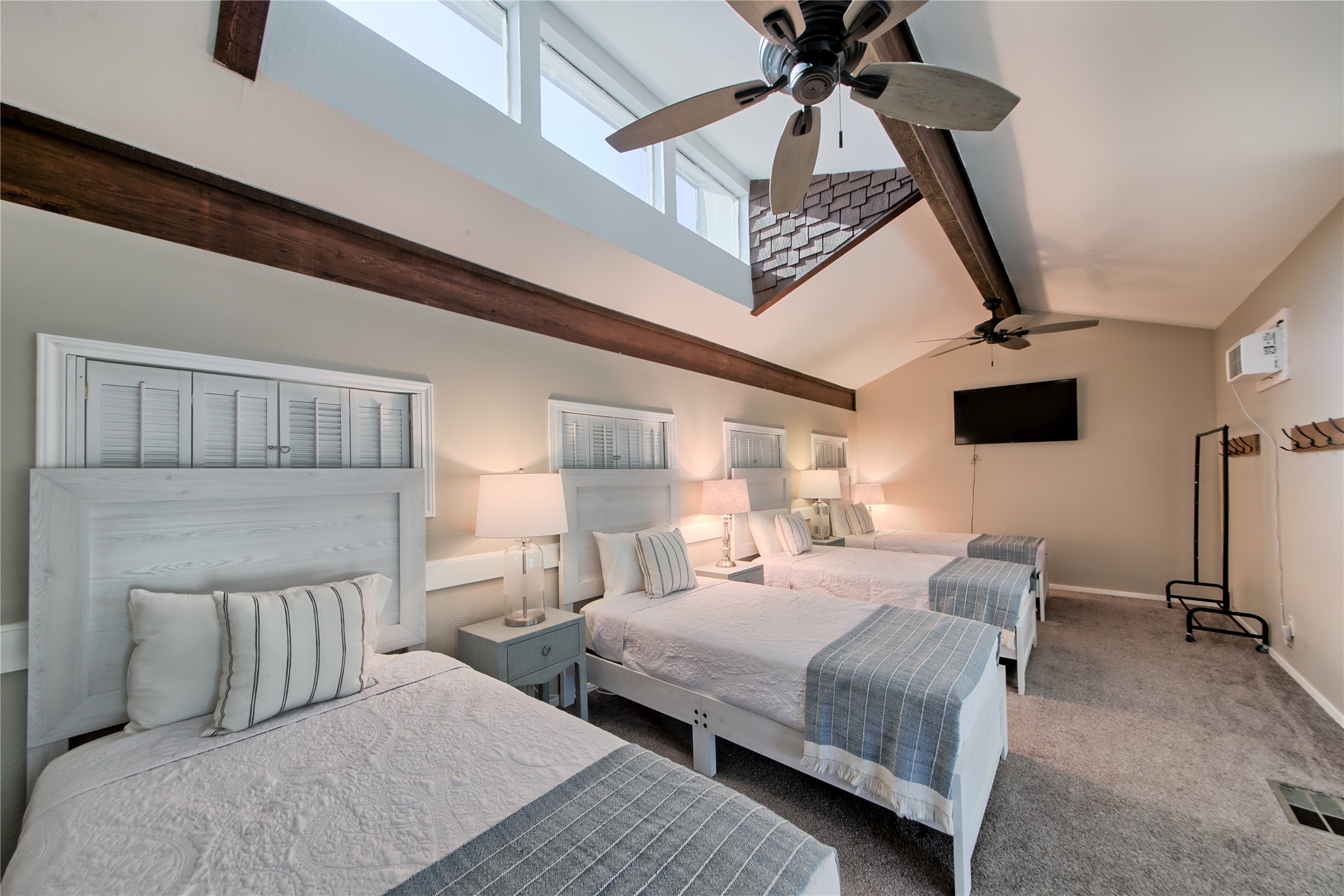 157 Comanche Point Leander, TX 78645 - Photo 23 of 36 a bedroom with a bed a flat screen tv and a ceiling fan