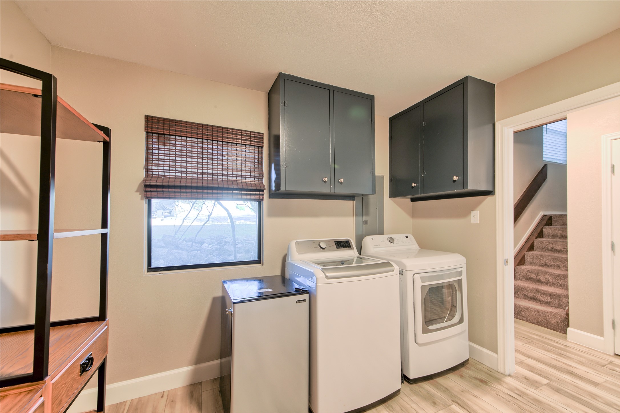 157 Comanche Point Leander, TX 78645 - Photo 26 of 36 a view of washer and dryer with wooden floor