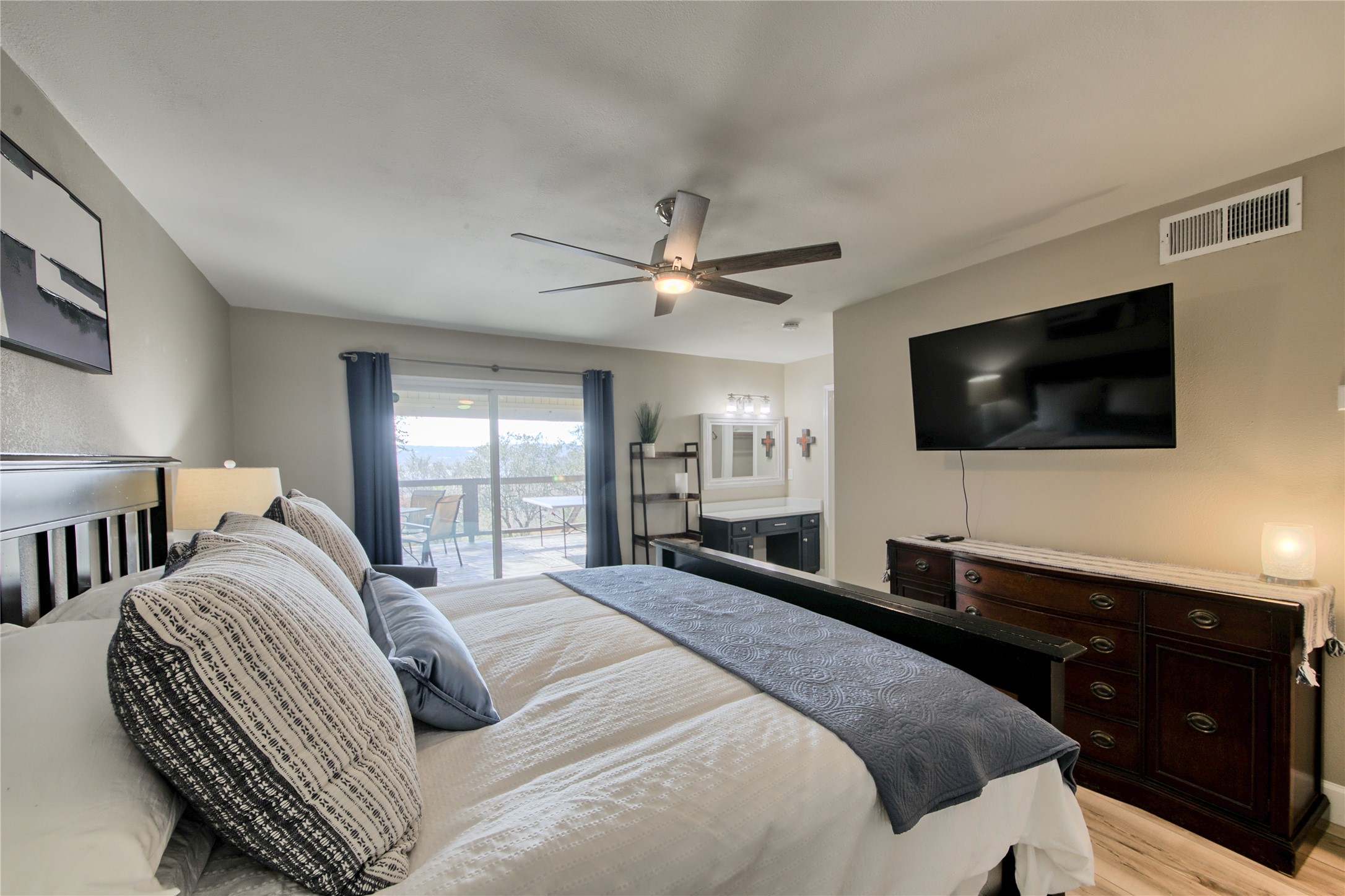 157 Comanche Point Leander, TX 78645 - Photo 28 of 36 a spacious bedroom with a large bed and a flat screen tv