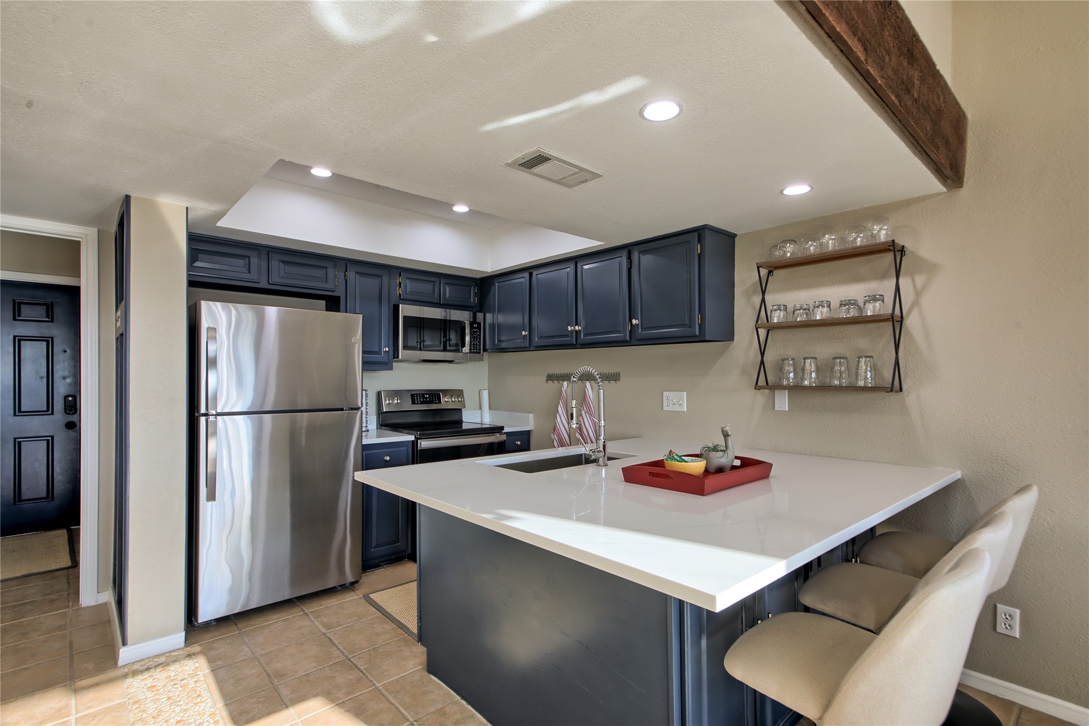 157 Comanche Point Leander, TX 78645 - Photo 3 of 36 a kitchen with stainless steel appliances granite countertop a sink refrigerator and microwave