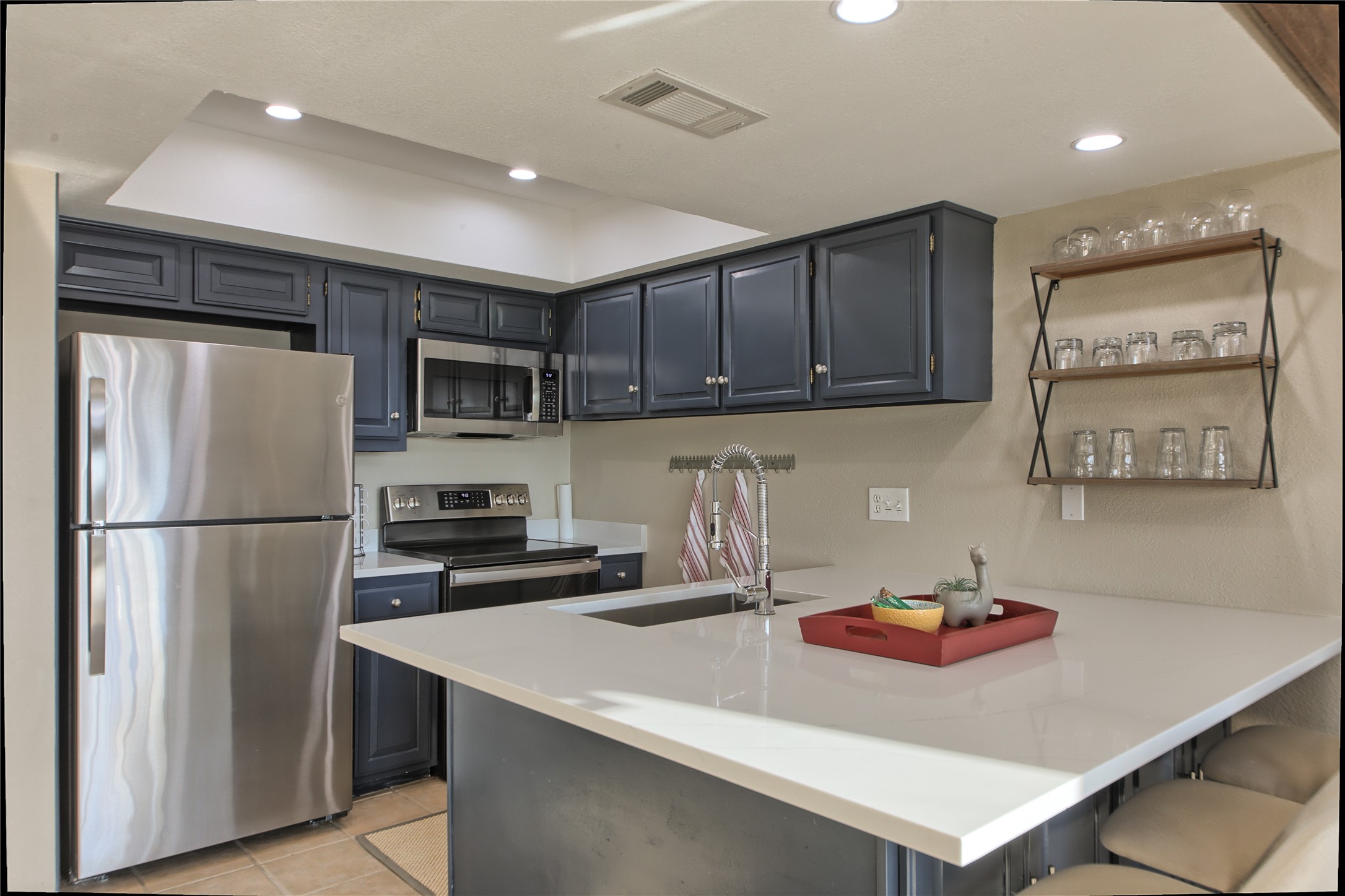 157 Comanche Point Leander, TX 78645 - Photo 4 of 36 a kitchen with refrigerator and cabinets