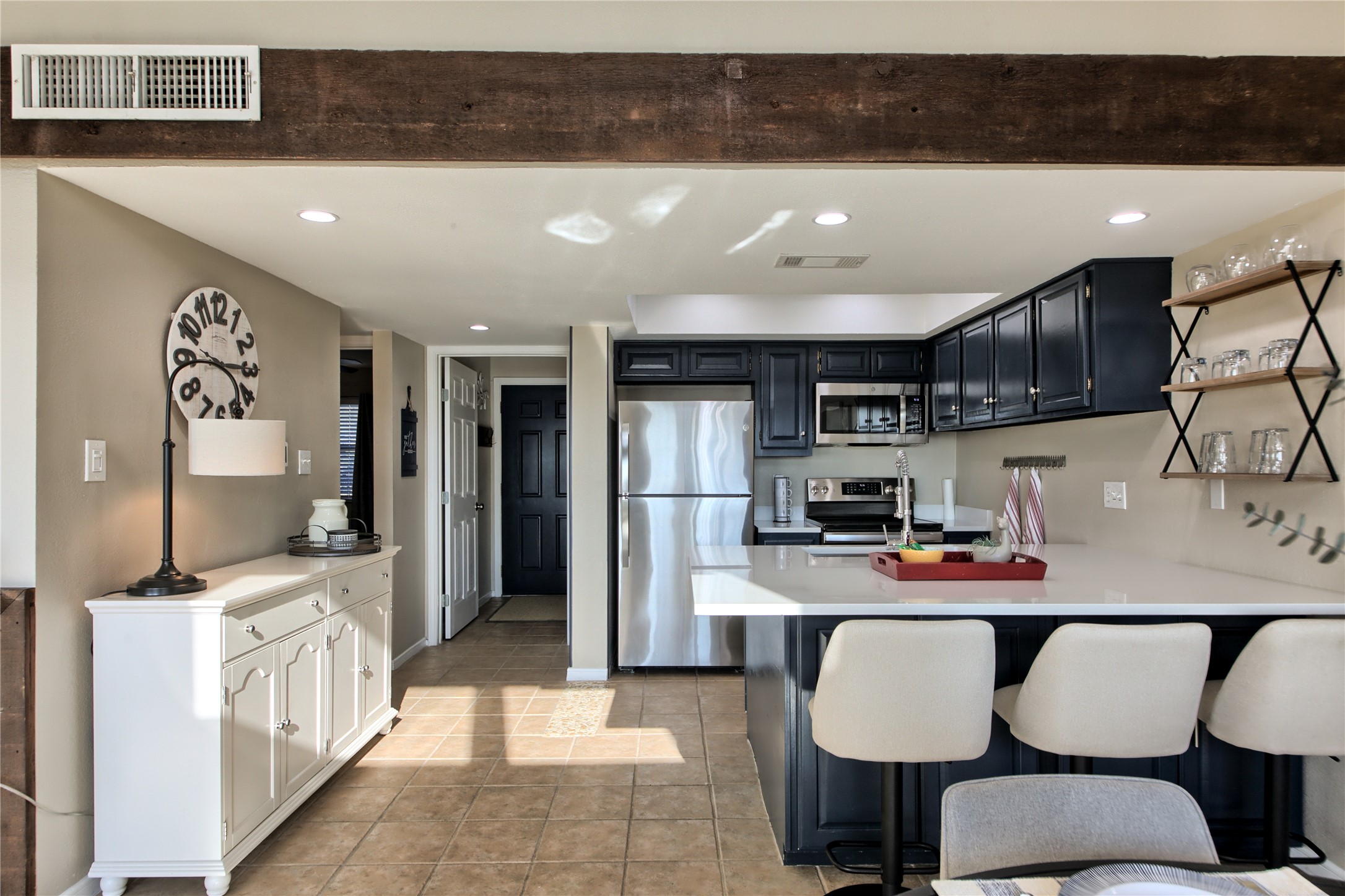 157 Comanche Point Leander, TX 78645 - Photo 6 of 36 a kitchen with stainless steel appliances granite countertop a sink refrigerator and cabinets