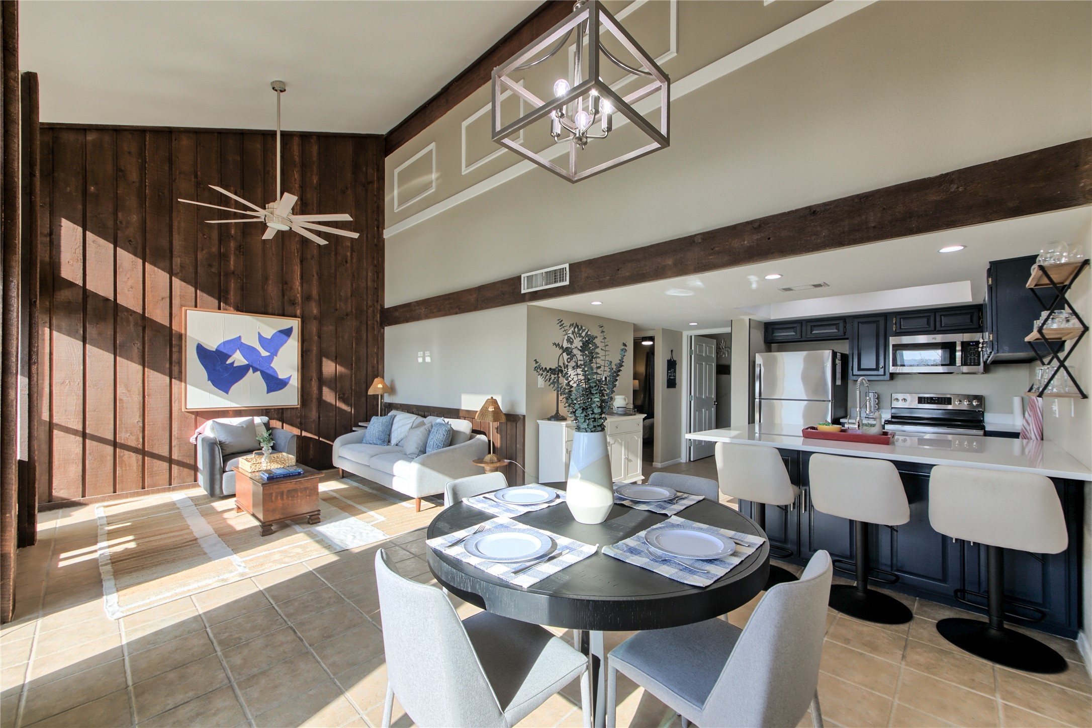 157 Comanche Point Leander, TX 78645 - Photo 8 of 36 a living room with furniture a chandelier and a dining table with wooden floor
