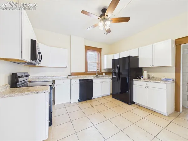 a kitchen with a stove top oven sink and cabinets