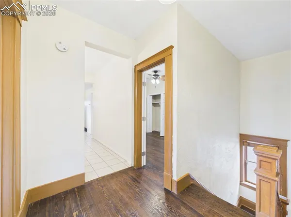 a view of an empty room with wooden floor