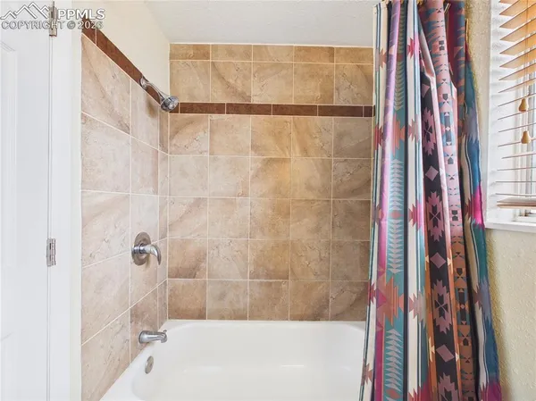 a bathroom with a bathtub and shower